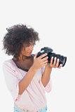 Smiling woman looking through digital camera