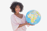 Smiling woman holding globe