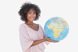 Happy woman holding globe