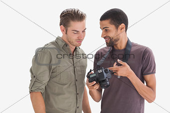 Photographer showing his friend photo on camera