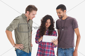 Stylish friends looking at tablet and smiling