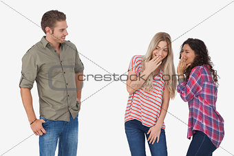 Girls laughing about secrets and leaving man out