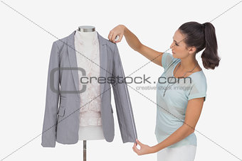 Fashion designer measuring blazer sleeve