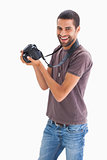 Stylish man holding camera and smiling