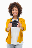 Pretty girl holding digital camera
