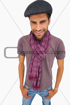 Smiling man wearing peaked cap and scarf
