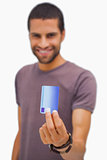 Smiling man holding credit card