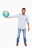 Smiling man holding out a globe