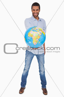 Happy man holding out a globe