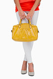 Woman in high heels holding yellow bag