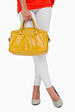 Woman in high heels standing with yellow bag