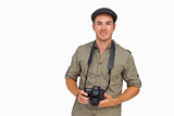 Man in peaked cap holding camera