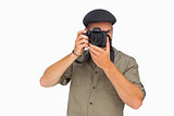 Man in peaked cap taking photo