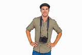 Happy man in peaked cap with camera around his neck