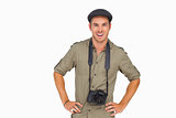 Smiling man in peaked cap with camera around his neck