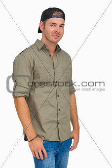 Man smiling and wearing baseball hat backwards