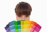 Happy woman with fringe showing colour charts close up