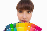 Pretty woman with fringe showing colour charts close up