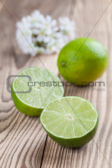 Limes on wooden background