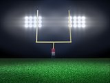 Empty football field with spotlight at night
