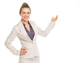 Smiling business woman pointing on copy space