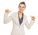 Smiling business woman pointing on herself