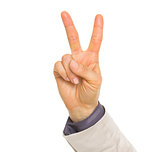 Closeup on hand of business woman showing victory gesture