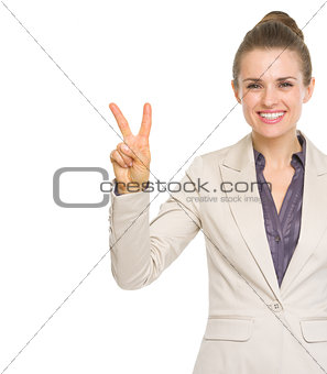 Happy business woman showing victory gesture