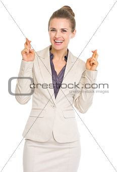 Happy business woman with crossed fingers