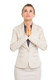 Portrait of business woman praying