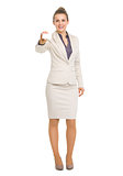 Full length portrait of smiling business woman showing business 