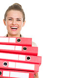 Smiling business woman holding stack of folders