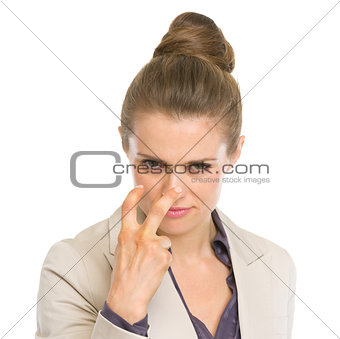 Serious business woman showing watching you gesture
