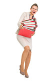 Full length portrait of frustrated business woman with stack of 