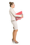 Full length portrait of happy business woman with stack of folde