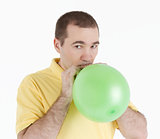 man inflates the balloon