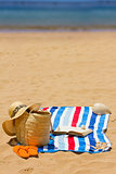 towel, sunbathing accessories and book