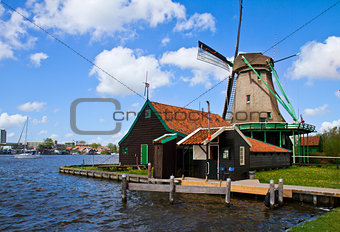dutch windmill over  river waters