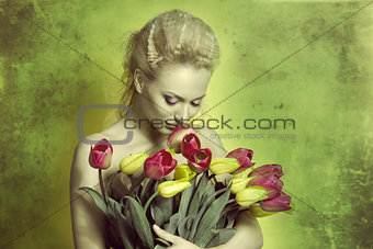 girl smelling tulips in green color