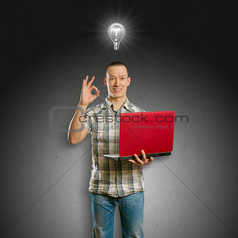 Idea Concept asian male with laptop in his hands shows OK
