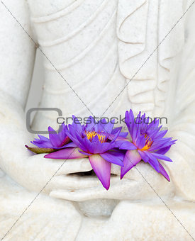 Fresh flowers in Buddha image hands