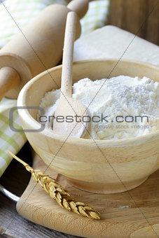 white flour in a wooden bowl - rustic style