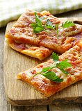 pizza of puff pastry with tomato sauce and parsley