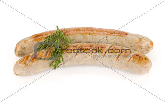 Two grilled sausages with dill
