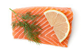 Fresh salmon piece with lemon slice and dill