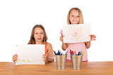 Young girls show their drawings