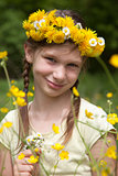 Girl with flowers on her head in nature