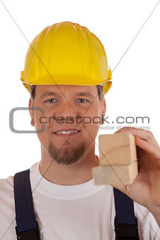 Construction worker holding wooden slats