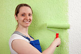 Young woman with paint roller