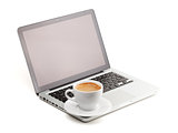 Hot cappuccino cup on laptop